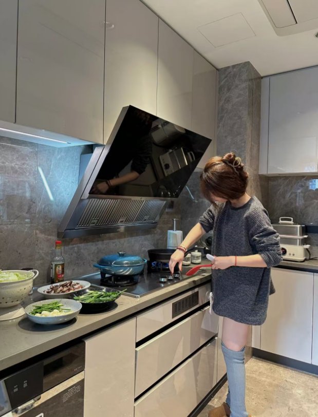 Zhangling, the author of Wok From China, cooking dinner in her kitchen in Yangzhou, China